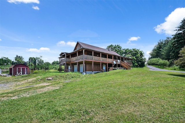 rear view of property featuring a yard and a wooden deck