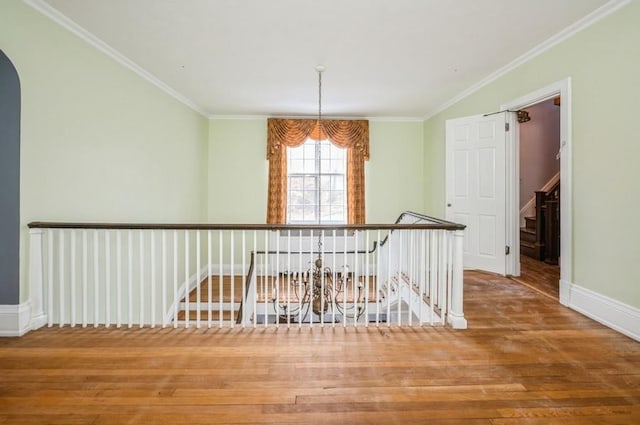 hallway featuring hardwood / wood-style floors and ornamental molding