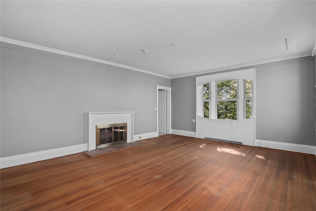 unfurnished living room featuring baseboard heating, crown molding, and hardwood / wood-style flooring