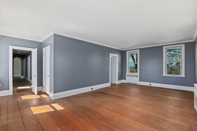 empty room featuring hardwood / wood-style flooring and crown molding