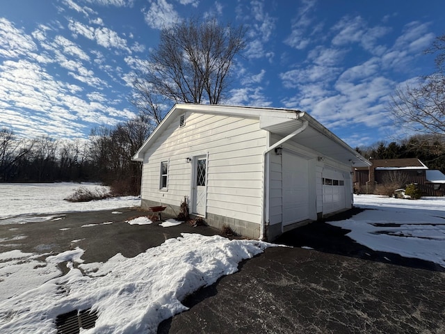 snow covered property featuring a garage