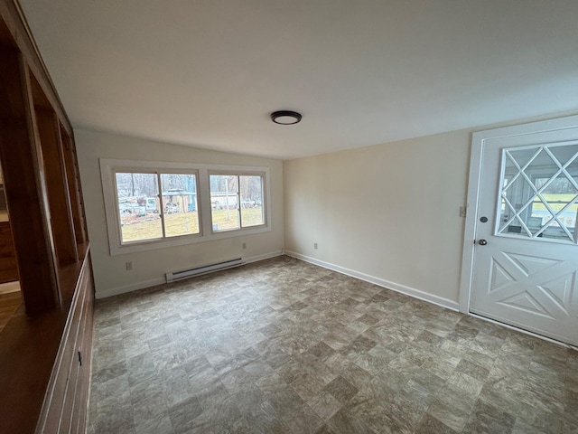 entryway with vaulted ceiling and a baseboard heating unit