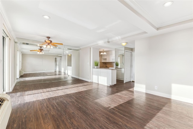 unfurnished living room featuring ceiling fan, dark hardwood / wood-style flooring, and ornamental molding