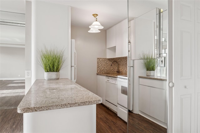 kitchen featuring decorative light fixtures, white cabinetry, white appliances, and kitchen peninsula