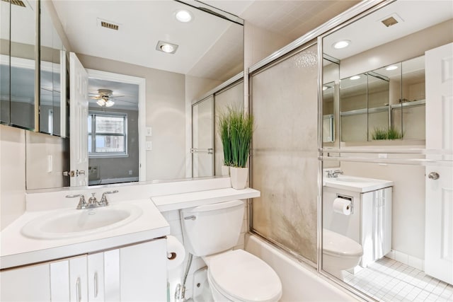 full bathroom featuring ceiling fan, vanity, combined bath / shower with glass door, and toilet