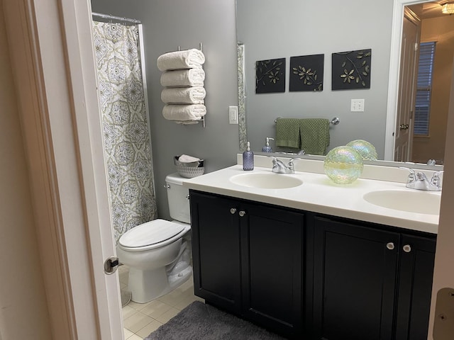 bathroom with tile patterned floors, vanity, and toilet