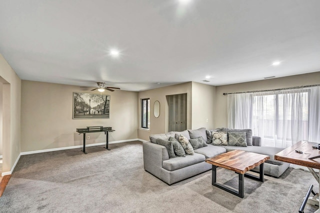 carpeted living room featuring ceiling fan