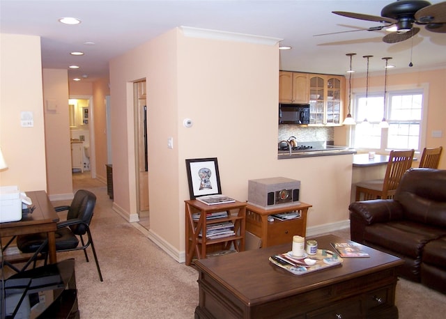 carpeted living room featuring ceiling fan and crown molding