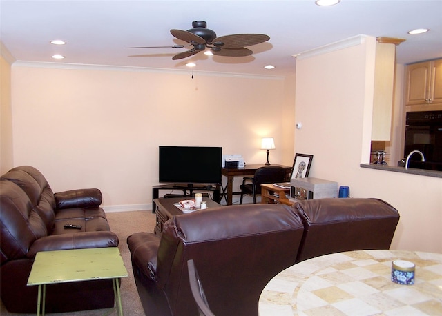 carpeted living room featuring ceiling fan, sink, and ornamental molding