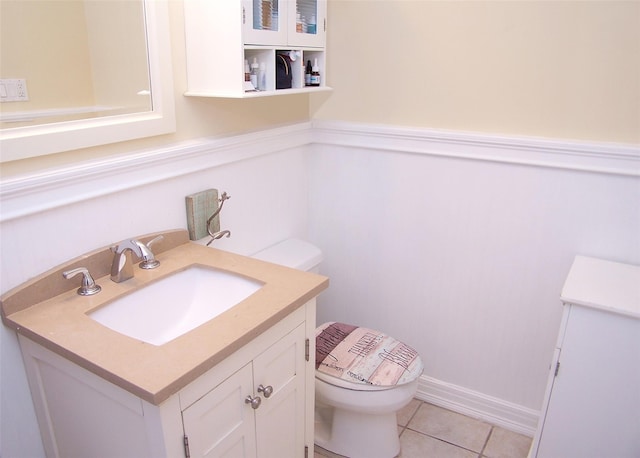 bathroom with tile patterned flooring, vanity, and toilet