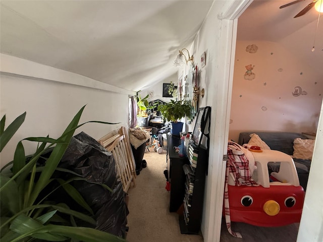 carpeted bedroom featuring ceiling fan and vaulted ceiling