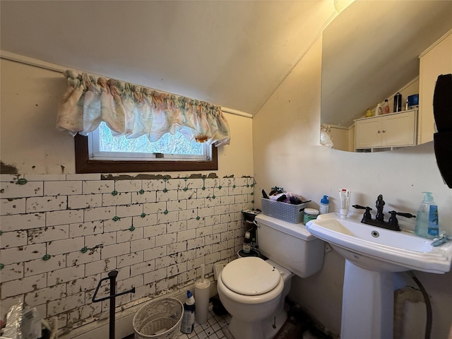 bathroom featuring tile patterned flooring, toilet, and lofted ceiling