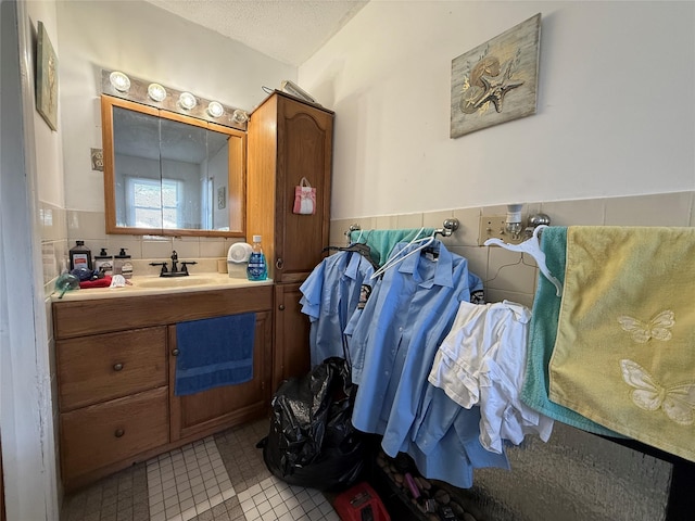 bathroom featuring tile patterned floors, vanity, and a textured ceiling