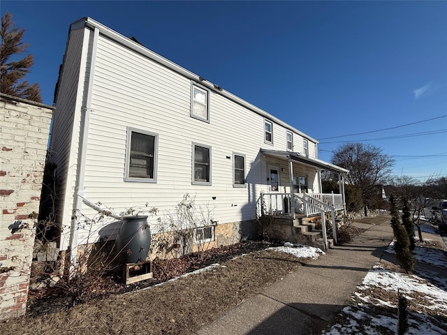 rear view of property with covered porch