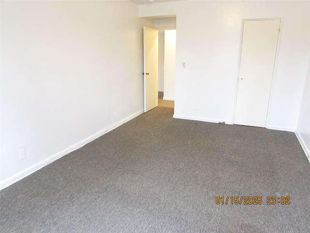 unfurnished bedroom with dark colored carpet