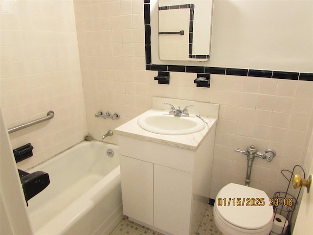 bathroom with toilet, a tub to relax in, tile patterned flooring, tile walls, and vanity