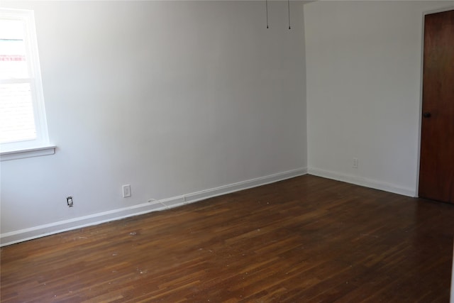 unfurnished room featuring dark wood-type flooring