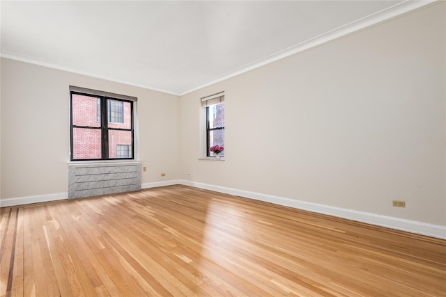 unfurnished room with crown molding and light hardwood / wood-style flooring