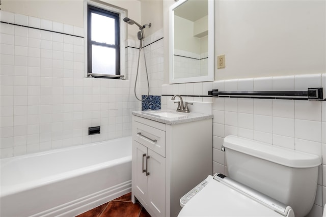 full bathroom featuring tile walls, vanity, toilet, and tiled shower / bath