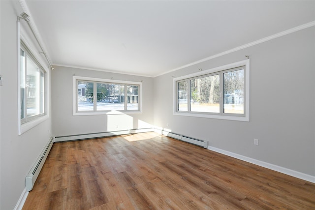 unfurnished room with hardwood / wood-style floors, ornamental molding, and a baseboard heating unit