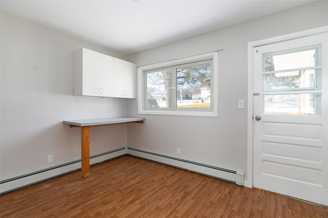 interior space featuring wood-type flooring and a baseboard radiator