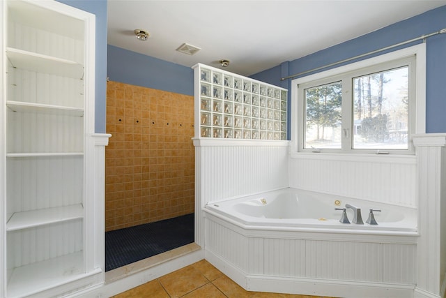 bathroom featuring tile patterned floors and separate shower and tub