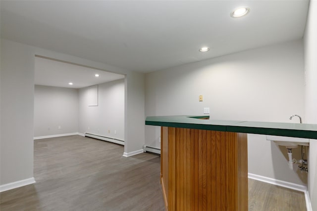 bar with hardwood / wood-style flooring and baseboard heating