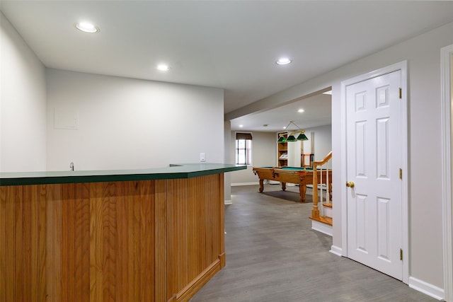 bar with wood-type flooring and billiards