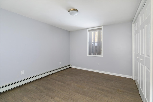 unfurnished bedroom featuring a closet, a baseboard radiator, and dark hardwood / wood-style floors