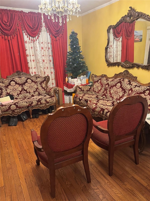 dining area featuring wood-type flooring, an inviting chandelier, and ornamental molding