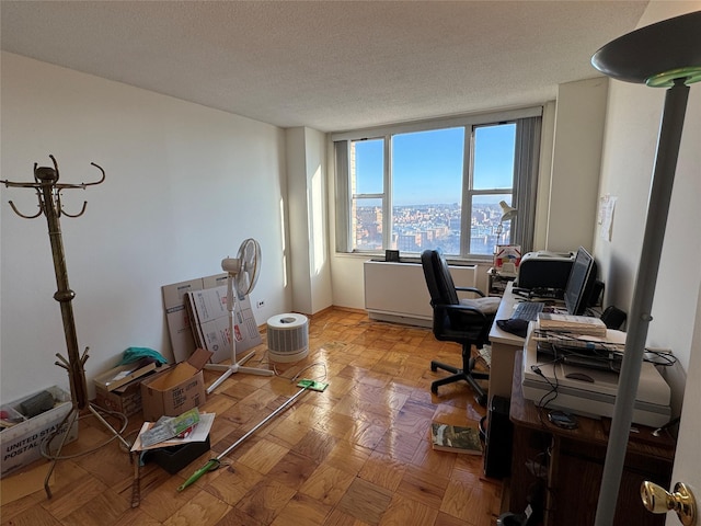 office space featuring light parquet flooring and a textured ceiling