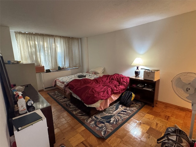 bedroom featuring light parquet flooring