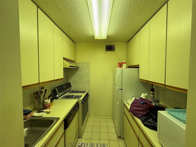 kitchen with decorative backsplash, a textured ceiling, white appliances, sink, and light tile patterned flooring