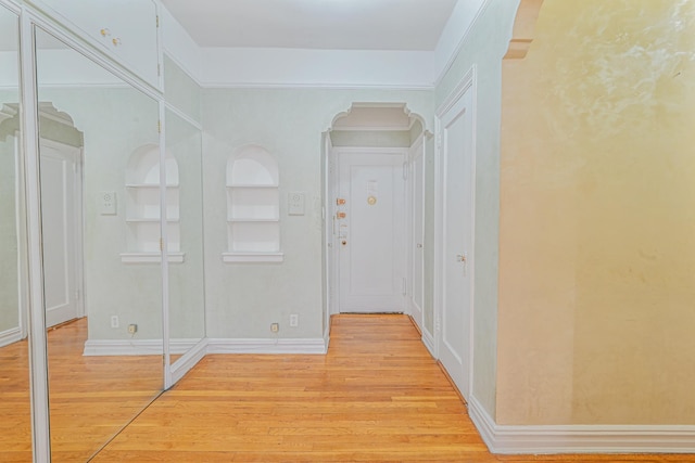 hall featuring hardwood / wood-style floors and built in features