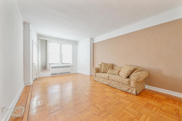 unfurnished room featuring radiator and light parquet flooring