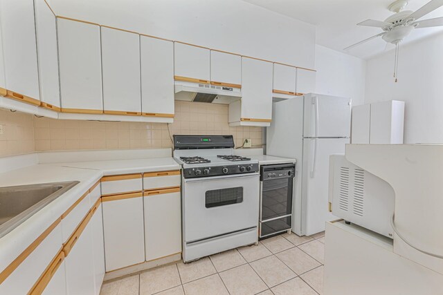 kitchen with white cabinetry, ceiling fan, tasteful backsplash, white appliances, and light tile patterned flooring