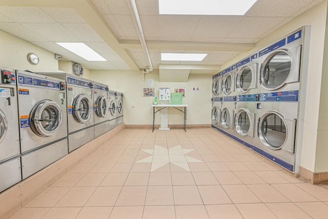 washroom featuring light tile patterned floors, stacked washer and clothes dryer, and independent washer and dryer