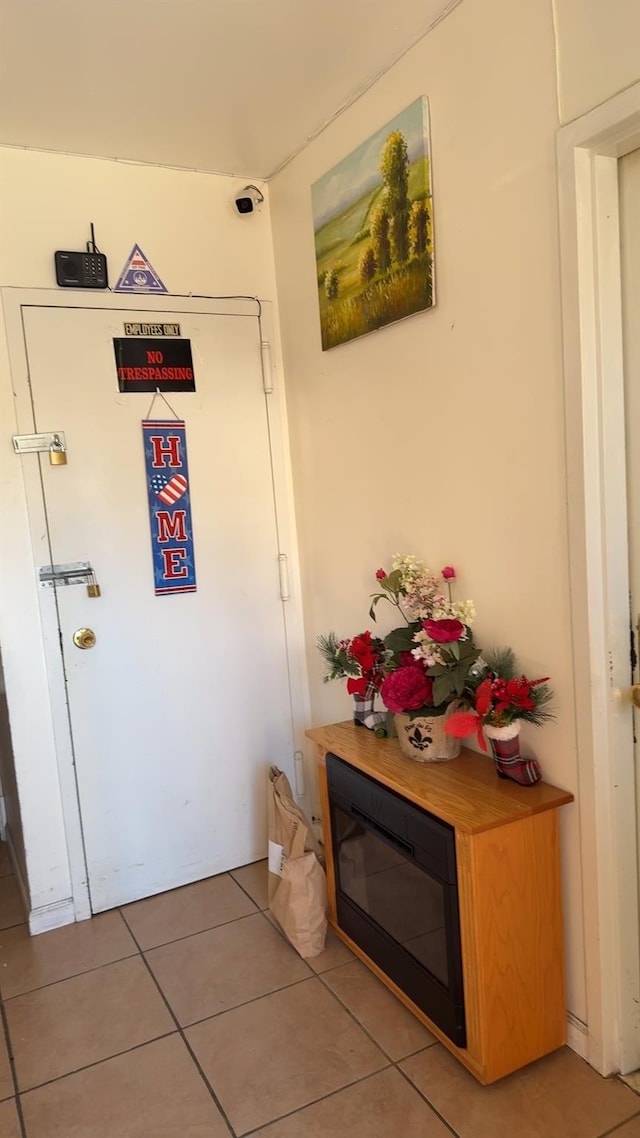 hall with tile patterned floors