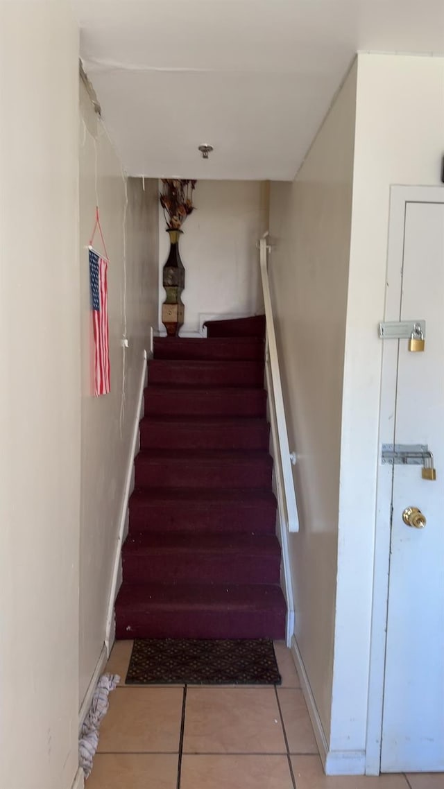 stairway with tile patterned flooring