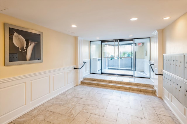 interior space featuring mail boxes and expansive windows