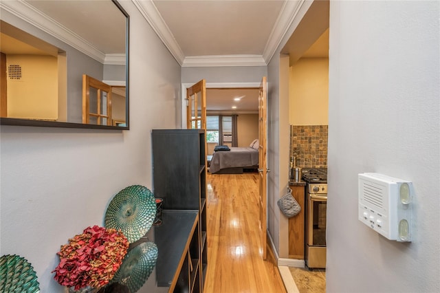 hall featuring hardwood / wood-style floors and crown molding