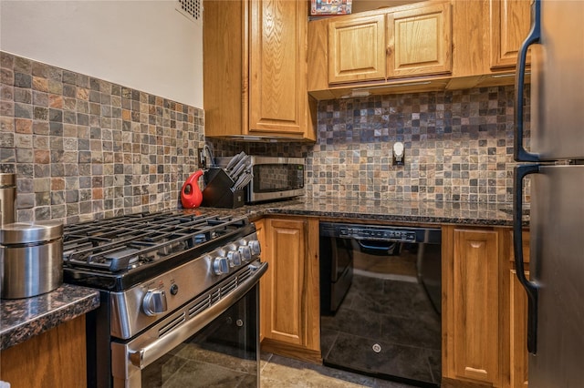 kitchen featuring dark stone countertops, decorative backsplash, and stainless steel appliances