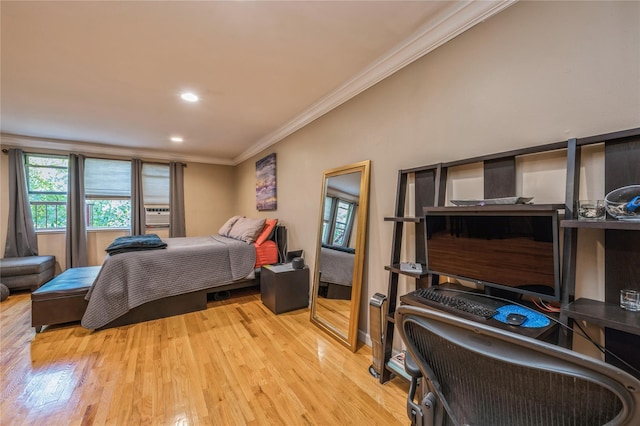 bedroom with ornamental molding and light hardwood / wood-style flooring