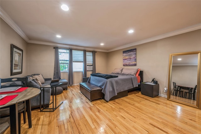 bedroom featuring ornamental molding and light hardwood / wood-style flooring