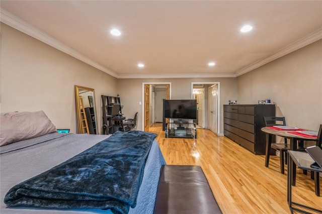 bedroom with ornamental molding and hardwood / wood-style flooring