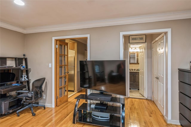 office featuring light hardwood / wood-style floors, crown molding, and french doors