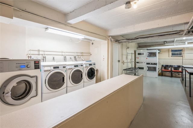 washroom with washing machine and dryer and stacked washing maching and dryer