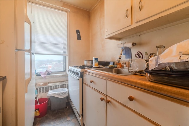 kitchen featuring sink and white gas stove