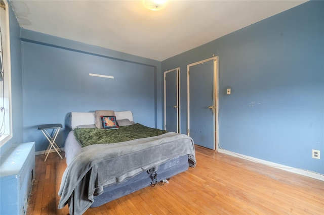 bedroom with hardwood / wood-style floors