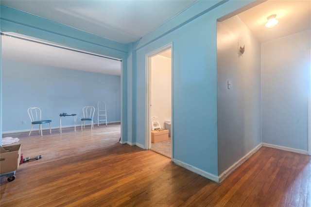 corridor featuring dark hardwood / wood-style floors